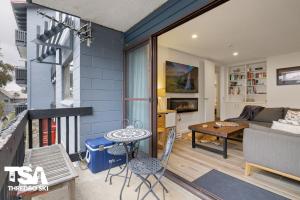 a living room with a couch and a table at Mowamba B2 in Thredbo