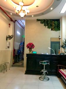 a salon with a black counter with flowers on the wall at Thiên Các Hotel in Quy Nhon