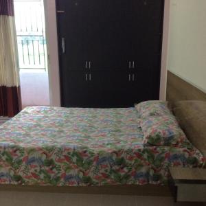 a bed with a quilt on it in a bedroom at ApartmenT - Homestays in Sylhet +28 photos