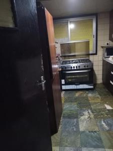 a kitchen with a stove top oven in a kitchen at Partition Al rigga in Dubai