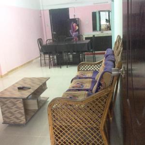 a living room with a couch and a table at ApartmenT - Homestays in Sylhet