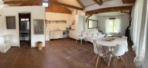 a kitchen and dining room with a table and chairs at Bolonia Beach Campus in Tarifa