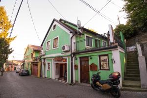 a motorcycle parked in front of a building at Gardoš rooms in Zemun