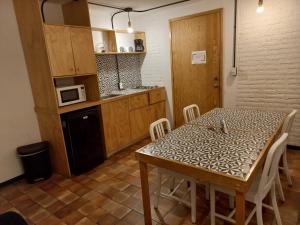 a kitchen with a table and chairs in a room at Coyoacan City Lofts in Mexico City
