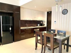a kitchen with a table with chairs and a counter top at Studio With SeaView in Nha Trang