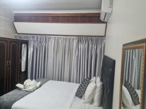 a bedroom with a bed and a large mirror at Margate Home Feeling Guesthouse House in Margate