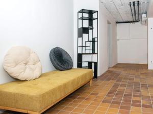 a room with a couch with a tire on the wall at Apartment with shared kitchen in Vedersø in Ulfborg +57 photos