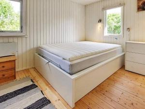 a bedroom with a large bed in a room at Holiday home Karrebæksminde LIV in Karrebæksminde