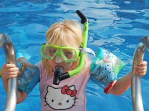 a young girl in a swimming pool wearing a snorkel at 6 person holiday home in Allinge in Allinge