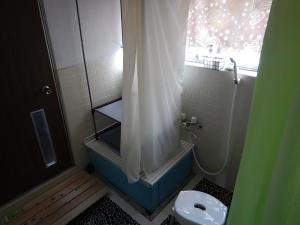 a bathroom with a shower and a toilet in it at Guesthouse Akaneko - Vacation STAY 09967v in Morioka