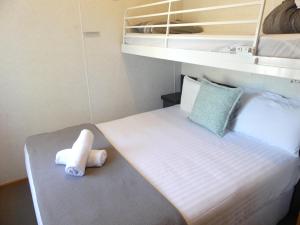 a small bedroom with a bed with a towel at Moama Riverside Holiday Park in Moama