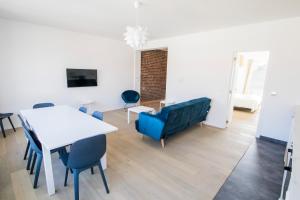 a living room with a table and chairs and a couch at Smart Appart - Clmenceau in Brussels