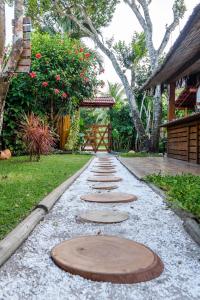 a path with stepping stones in a garden at Pousada NÔ Caraíva in Caraíva