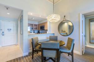 a dining room with a table and chairs and a mirror at Breathtaking 2 Bedroom Condo Placed at Ritz Carlton-Key Biscayne in Miami