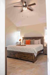 a bedroom with a bed with a ceiling fan at Kelowna Bed & Breakfast - CHATHAM HOUSE in Kelowna