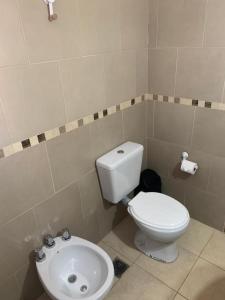 a bathroom with a toilet and a sink at Casita en plottier in Plottier