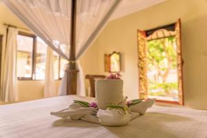 a room with a bed with towels and a window at Coral Bay Bungalows Amed Bali in Amed +64 photos