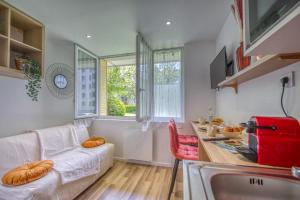 een woonkamer met een witte bank en een tafel bij Le Taillefer 4 - L'Oasis in Rhut