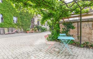 a blue table and two chairs sitting next to a building at Nice Home In Sand With 3 Bedrooms And Wifi in Sand