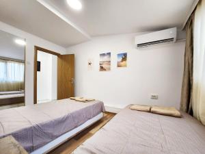 a bedroom with two beds and a window at Sun-kissed Varna Getaway in Varna City