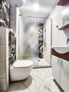 a bathroom with a shower and a toilet and a sink at Sun-kissed Varna Getaway in Varna City