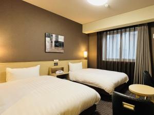 Postel nebo postele na pokoji v ubytování ​Hotel Route-Inn Kumagaya​