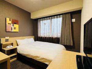 Postel nebo postele na pokoji v ubytování ​Hotel Route-Inn Kumagaya​