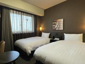 Postel nebo postele na pokoji v ubytování ​Hotel Route-Inn Kumagaya​