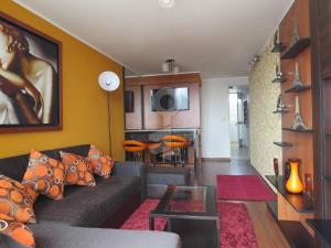 a living room with a couch and a table at Temporal Apartment in Lima