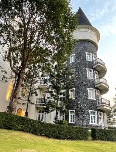 a large castle like building with a tree at Blue Sky Khao Kho Castell Condo in Campson