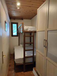 a bunk room with two bunk beds and a door at Maisonette rustique- pinède piscine in Argelès-sur-Mer