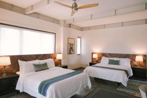 Postel nebo postele na pokoji v ubytování Kaimana Resort Siargao