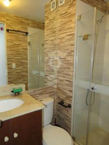 a bathroom with a shower and a toilet and a sink at Temporal Apartment in Lima