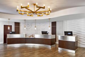 a lobby with a reception desk and a chandelier at SpringHill Suites Memphis Downtown in Memphis