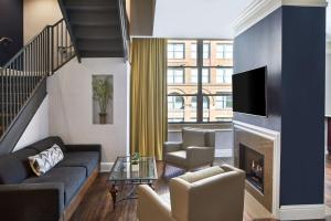 a living room with a couch and a fireplace at SpringHill Suites Memphis Downtown in Memphis