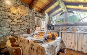 a table in a kitchen with a stone wall at Casa Del Pepe in Chamois