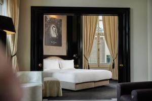 a bedroom with a bed and a large window at InterContinental Amstel Amsterdam, an IHG Hotel in Amsterdam