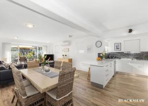 a kitchen and living room with a table and chairs at Seaview by the Cliff in Surf Beach