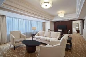 uma sala de estar com um sofá, cadeiras e uma mesa em Sheraton Xi'an Hotel em Xi'an