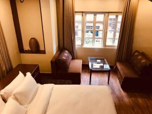 Een bed of bedden in een kamer bij Courtyard Pujan Hotel