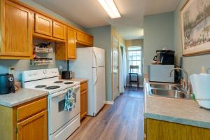 a kitchen with a white stove and a sink at Horn Lake Vacation Rental about 14 Mi to Memphis! in Horn Lake