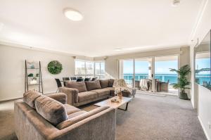 a living room with a couch and a table at Oscar On Main Beach Resort in Gold Coast