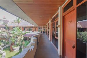 an internal view of a building with tables and benches at Dequr Hotel Dipati Ukur Mitra RedDoorz in Bandung