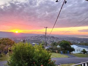 a sunset from the top of a house at Bateau Family Retreat - Magical sunset views in Bateau Bay