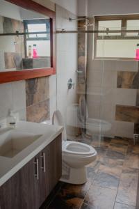 a bathroom with a toilet and a sink and a shower at Finca en Marinilla in Marinilla
