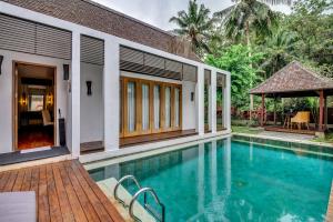 a swimming pool in front of a villa at The Samaya Ubud in Ubud