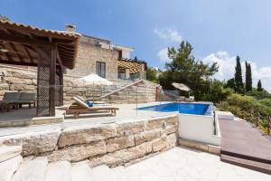 a villa with a swimming pool and a house at Aphrodite Hills 4 bedroom villa with private infinity pool in Kouklia