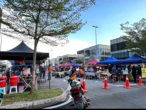 a motorcycle parked in a parking lot with orange cones at Ayden Hostel Airport Transit - KLIA in Sepang +32 photos