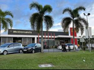 a macdonalds store with cars parked in front of it at Ayden Hostel Airport Transit - KLIA in Sepang