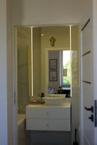 a bathroom with a sink and a large mirror at Modern apartment close to Katowice Center! in Katowice